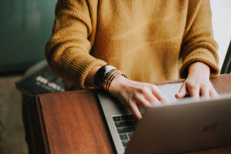 A woman typing on her computer.