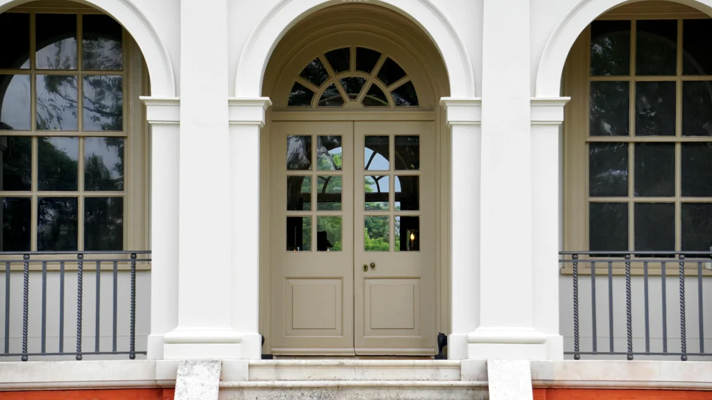 A cream door on large house.